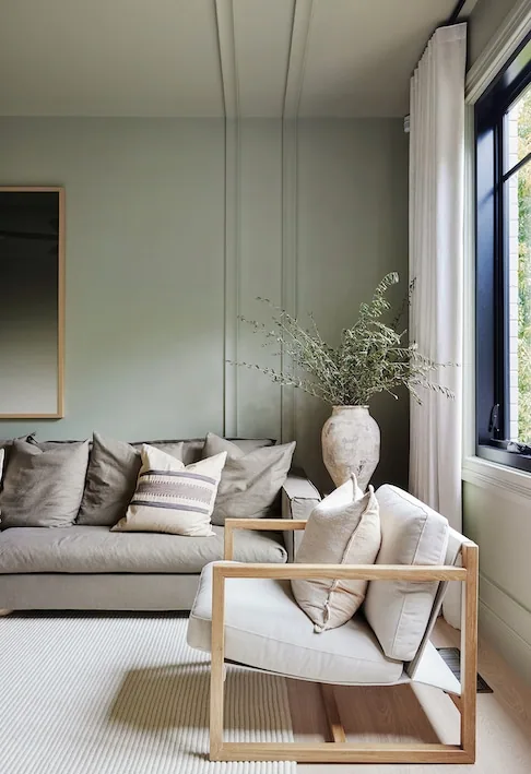 Living room featuring vertical decorative timber mouldings creating subtle wall panelling detail with interior skirting boards and natural light