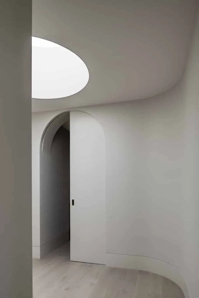Contemporary minimalist hallway featuring clean lines, light-filled design, and curved Intrim skirting board for a sophisticated finish.