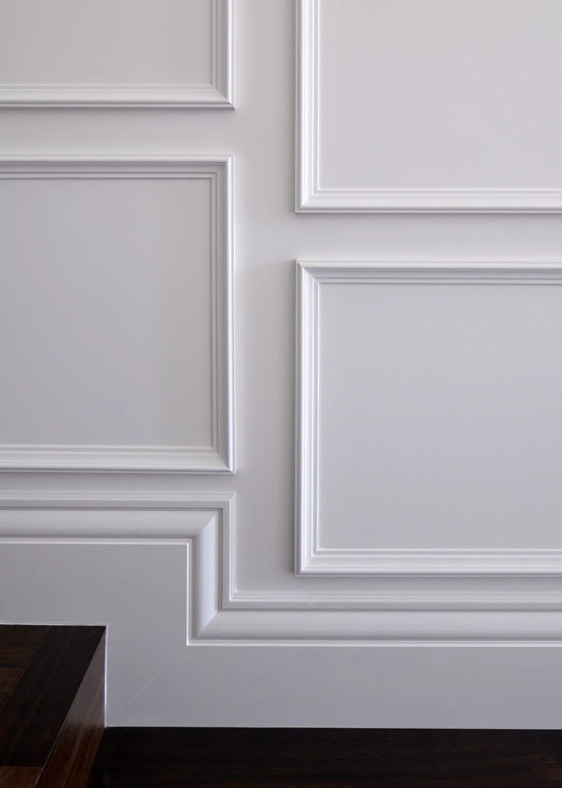Decorative timber inlay moulding profile forming detailed wall panel feature in a refined interior