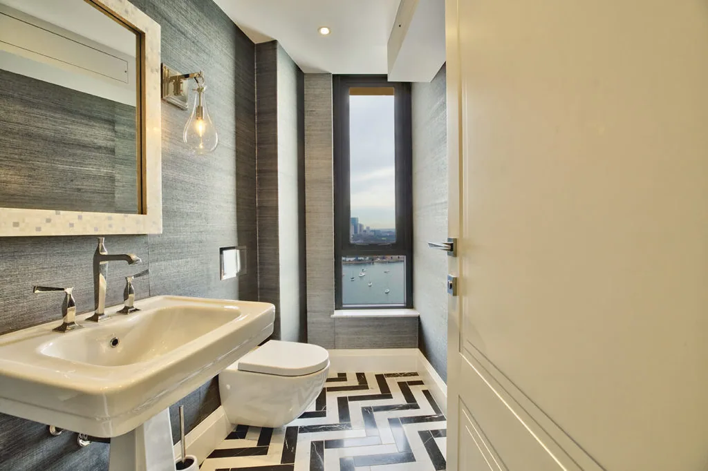 Modern apartment bathroom design with 1920s-style black and white geometric flooring