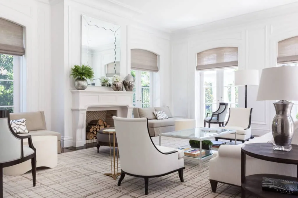 Refined living room with decorative wall panelling, coffered detailing, and a sculpted fireplace.
