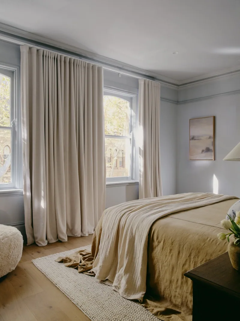 Bedroom with tall windows and ceiling cornice in Potts Point terrace renovation by Convict Interiors featuring Intrim skirting, architraves, sill nosing, and picture rail mouldings
