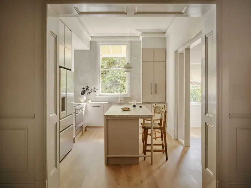 Light-filled kitchen framed by detailed architraves in Victorian terrace Potts Point renovation by Convict Interiors, featuring Intrim skirting, architraves and wainscoting profiles