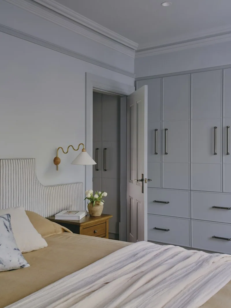 Bedroom with built-in wardrobes and detailed cornices in Victorian terrace renovation by Convict Interiors using Intrim skirting, architraves, and picture rail.