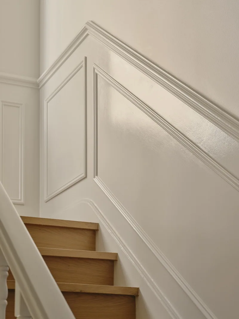 Staircase with decorative wall panelling and handrail in Potts Point terrace renovation by Convict Interiors featuring Intrim mouldings