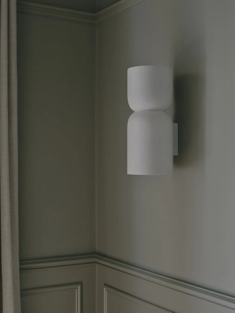Wall sconce above classic wall panelling in Victorian terrace renovation by Convict Interiors featuring Intrim moulding profiles