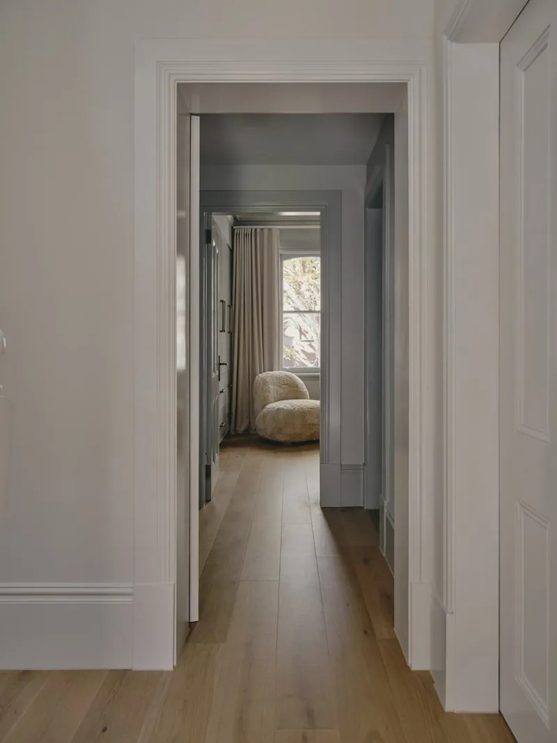 Hallway view through layered architraves in Victorian terrace renovation by Convict Interiors, showcasing Intrim skirting & architraves